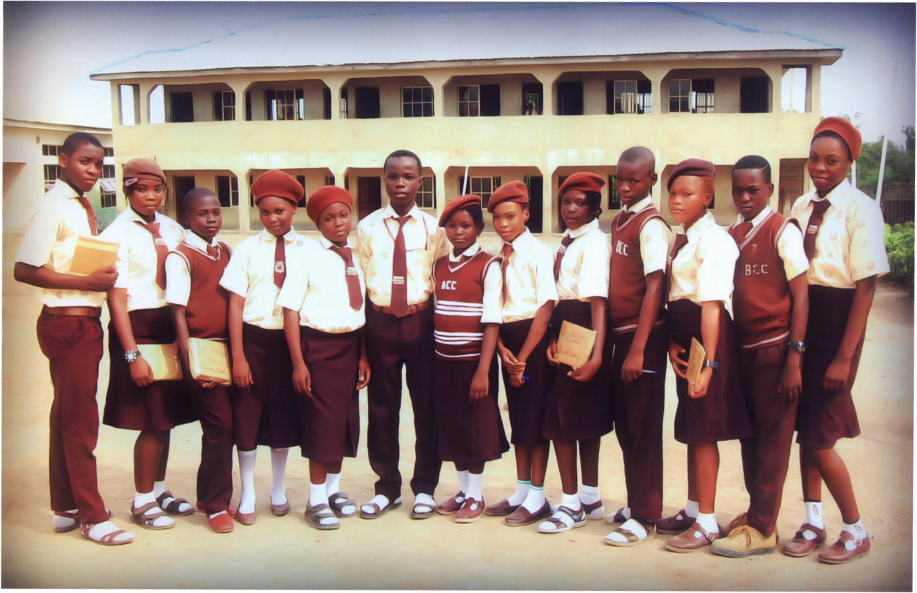 Brown Comprehensive College students standing together in uniform outside their school building