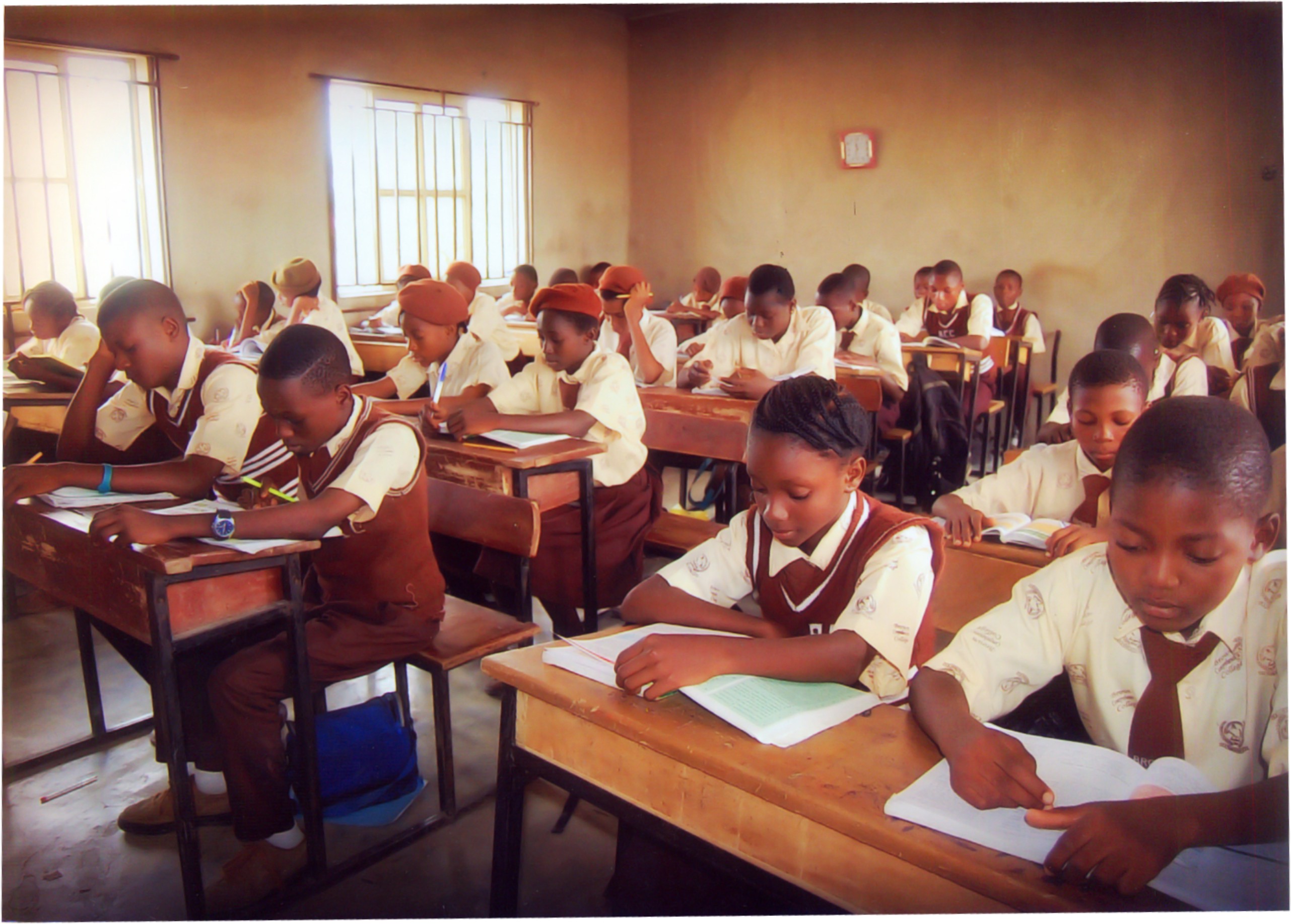Brown Comprehensive College students reading and writing during a classroom lesson